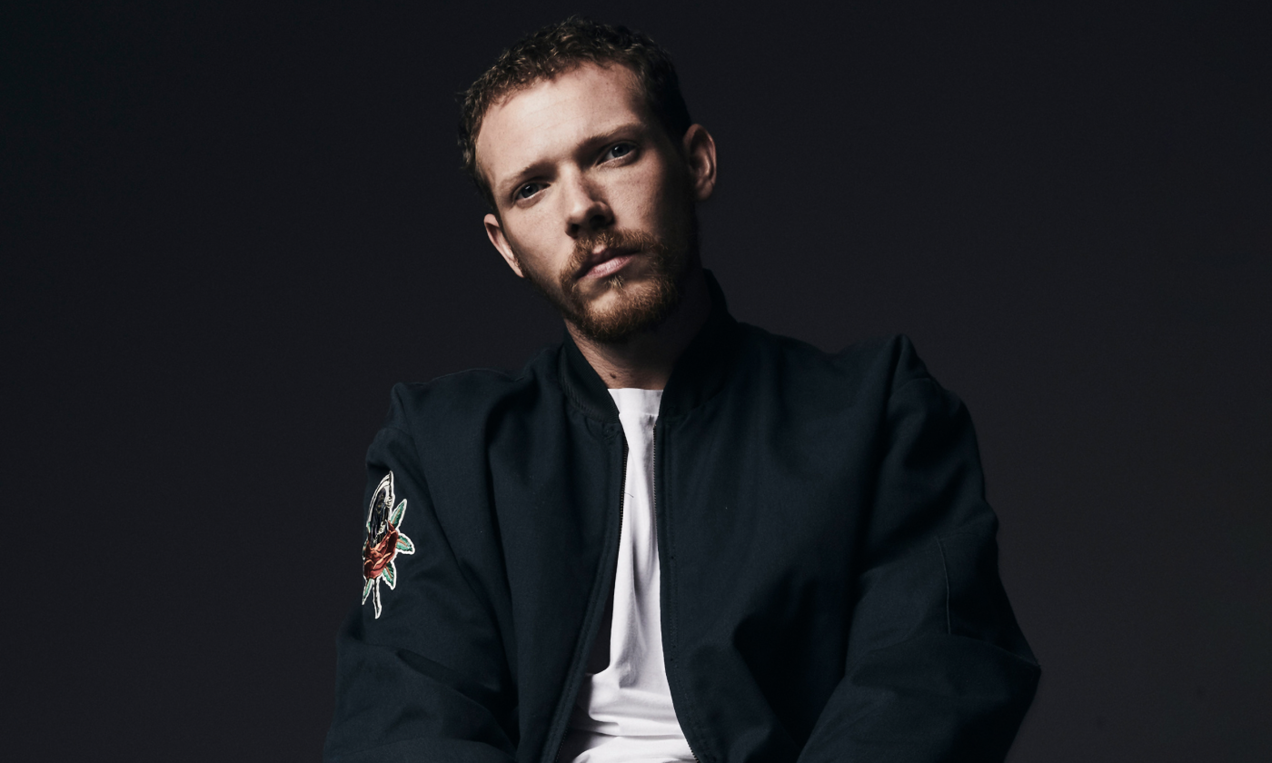 Matt Maeson poses in front of a black background.