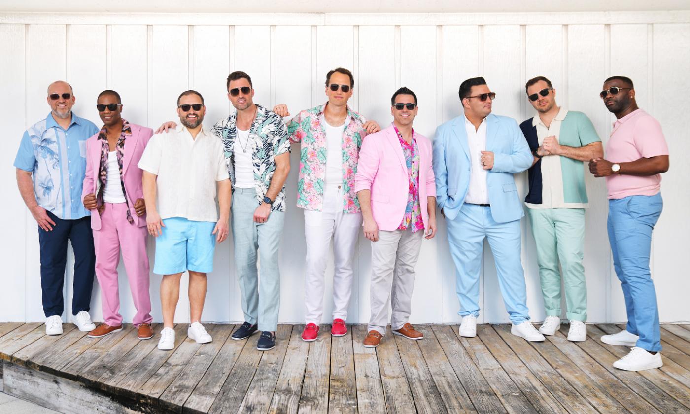 Straight No Chaser wears colorful clothing and poses for the camera.