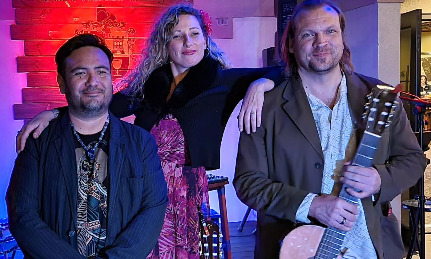 Three musicians, Dorian Lopez, Yael Dray, and Jonathan Dotson, standing on the stage