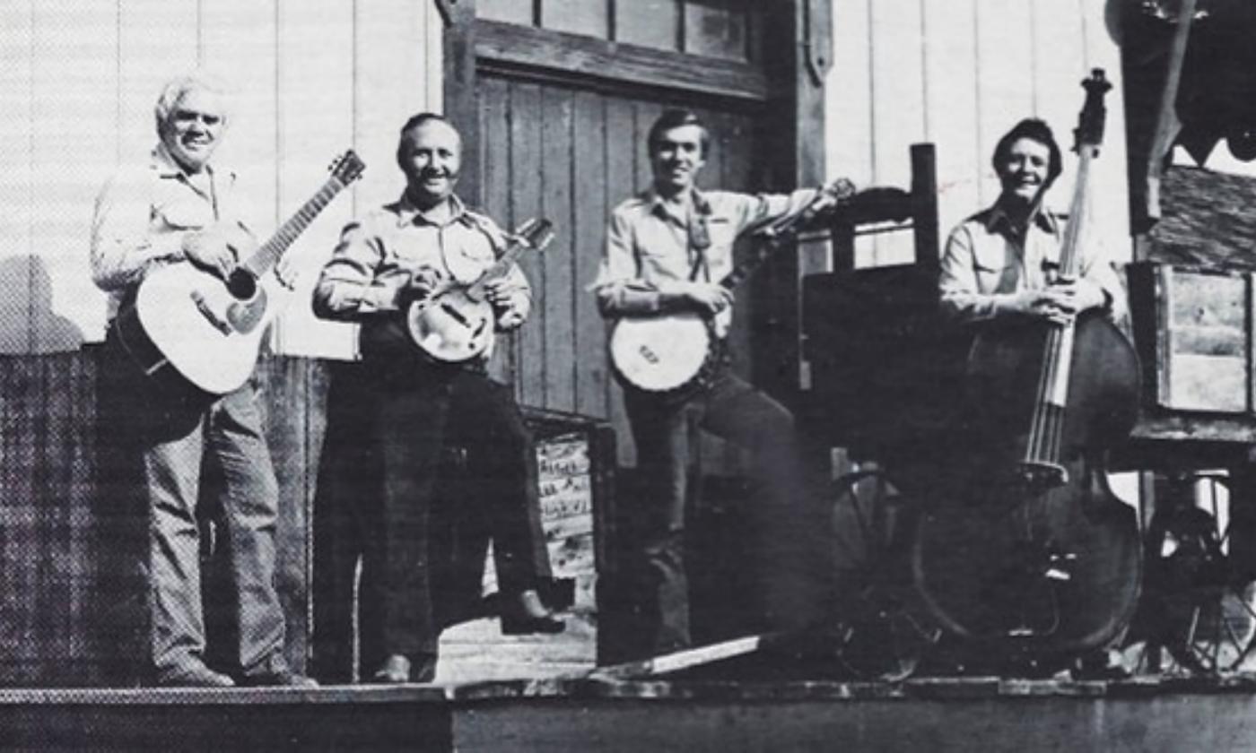 Four members of the Shady Grove Ramblers in the 1960s. They pose shoulder to shoulder with their musical instruments