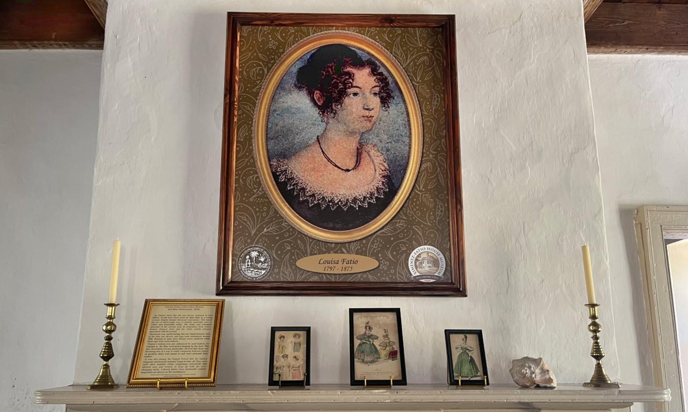 A portrait of Louisa Fatio above a historical fireplace at the Ximenez Fatio House Museum in St Augustine FL