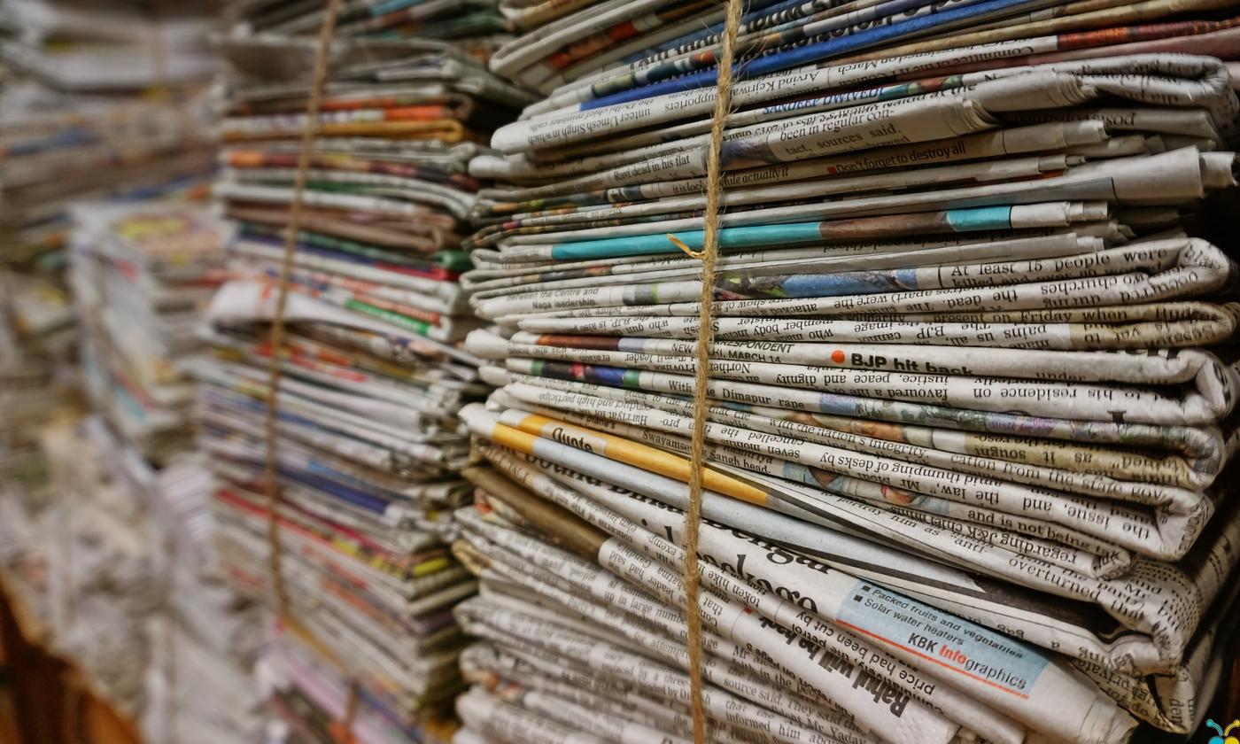 Bundles of newspaper tied with twine.