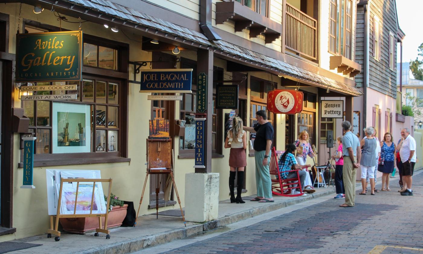 A section of St. Augustine's art district during First Friday Art Walk, with a view of galleries and art enthusiasts