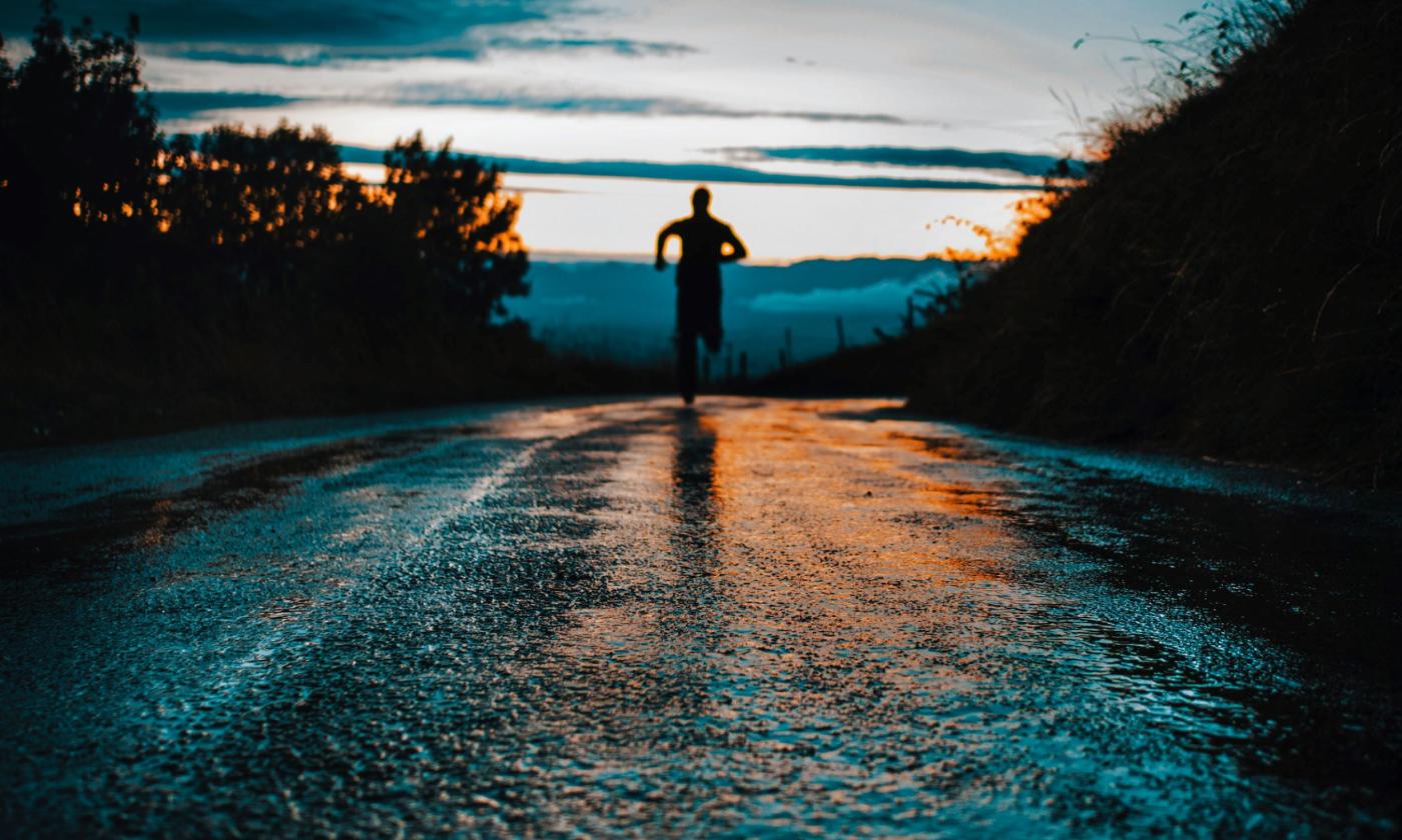 A man jogs during the evening.