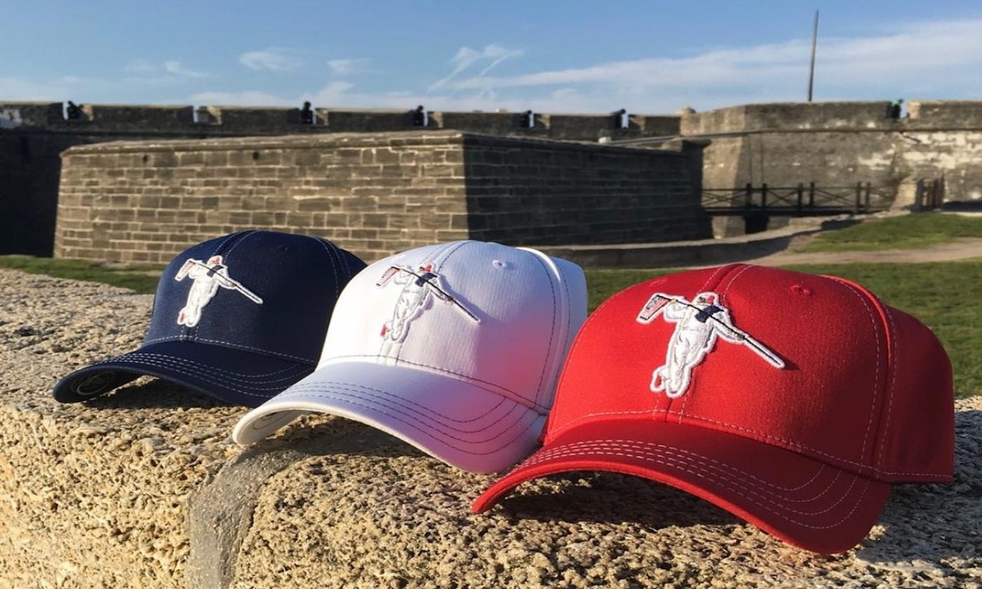 baseball hats on a wall by the fort