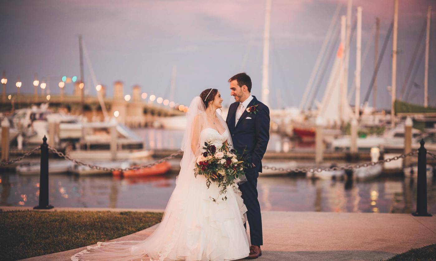Wedded Couple in front of the marina and Bridge of Lions, photo by Bow Tie Photography