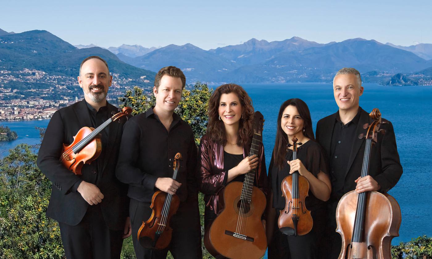 The four members of the Pacifica Quartet stand with their instruments on a hill in Spain, with guitarist Sharon Isbin