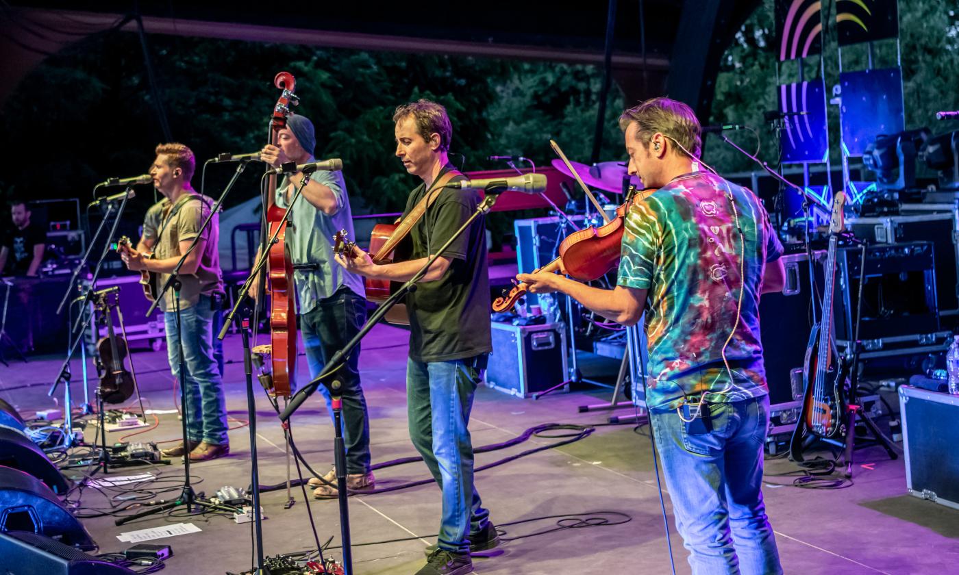 The Yonder Mountain String Band, on stage in bright colors, photo by Dave Vann
