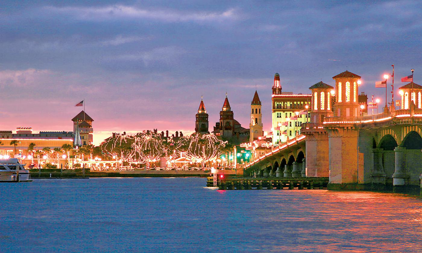 St. Augustine from across the river, with the Bridge of Lions and the city illuminated for Nights of Lights