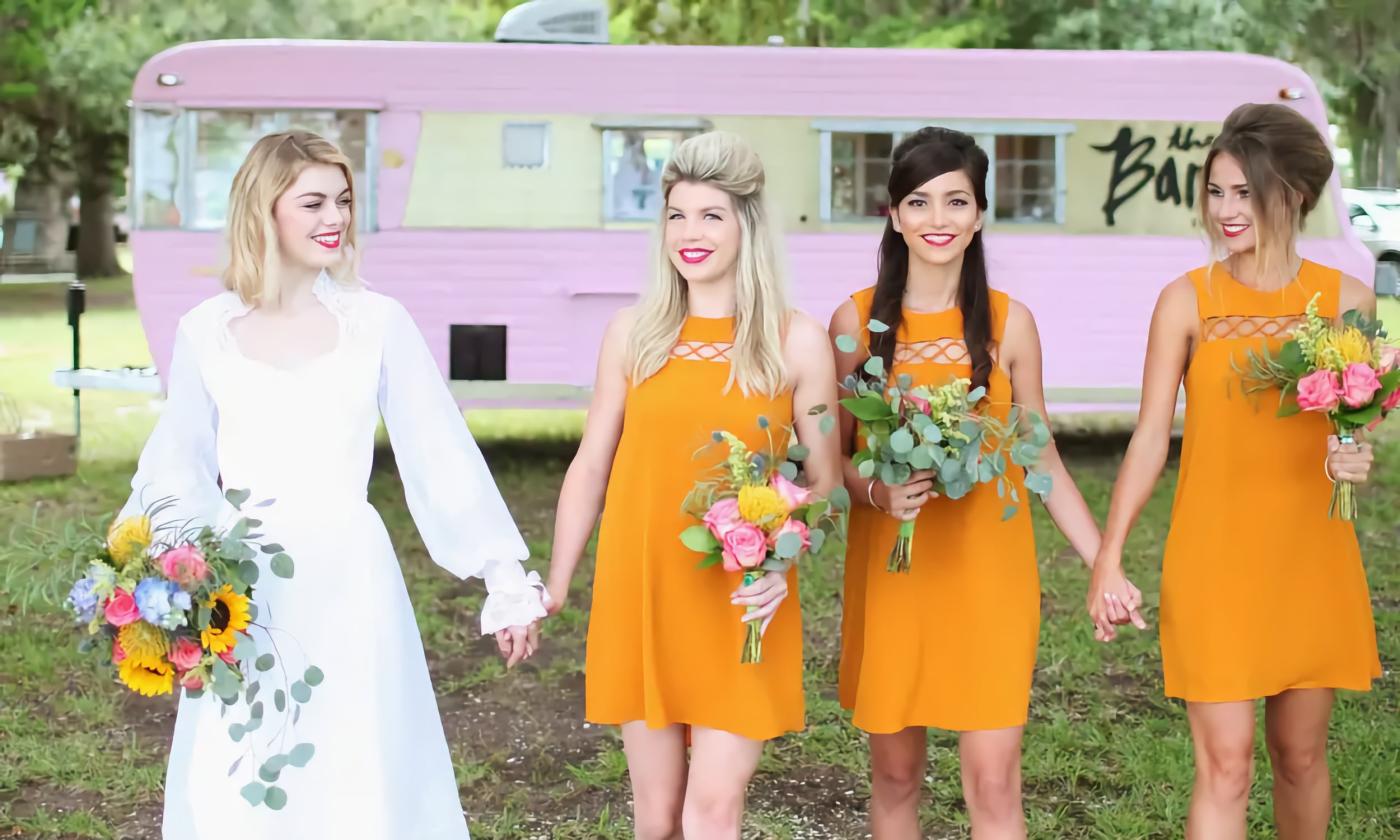 Bride and bridesmaids walking in front of the Bardot beauty trailer