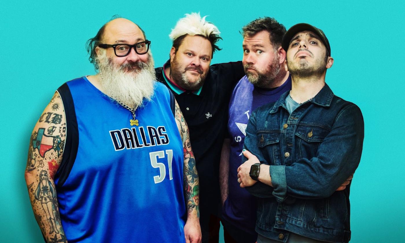 Bandmates from Bowling For Soup and Lit smile and pose in front of a teal background.