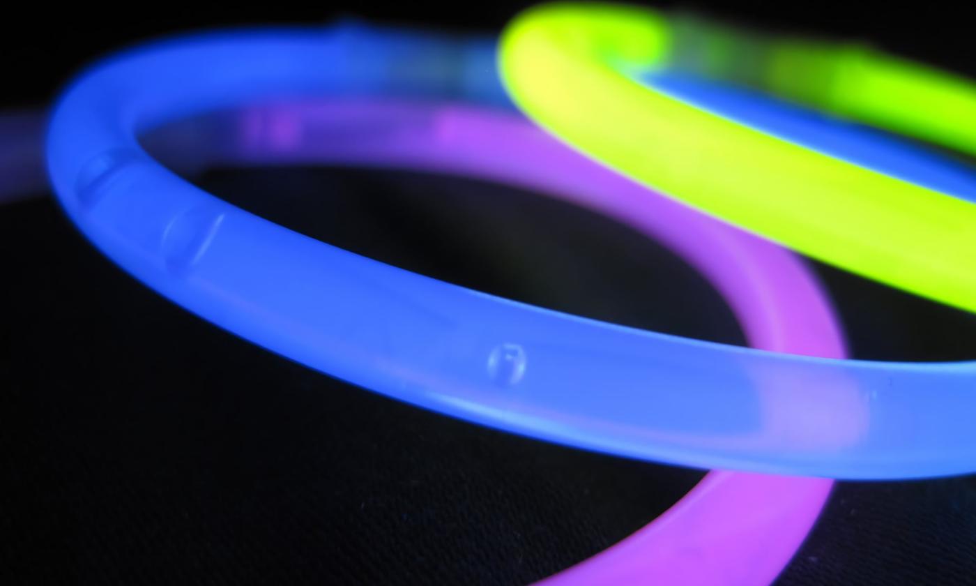Glow bracelets glowing purple, blue, and yellow