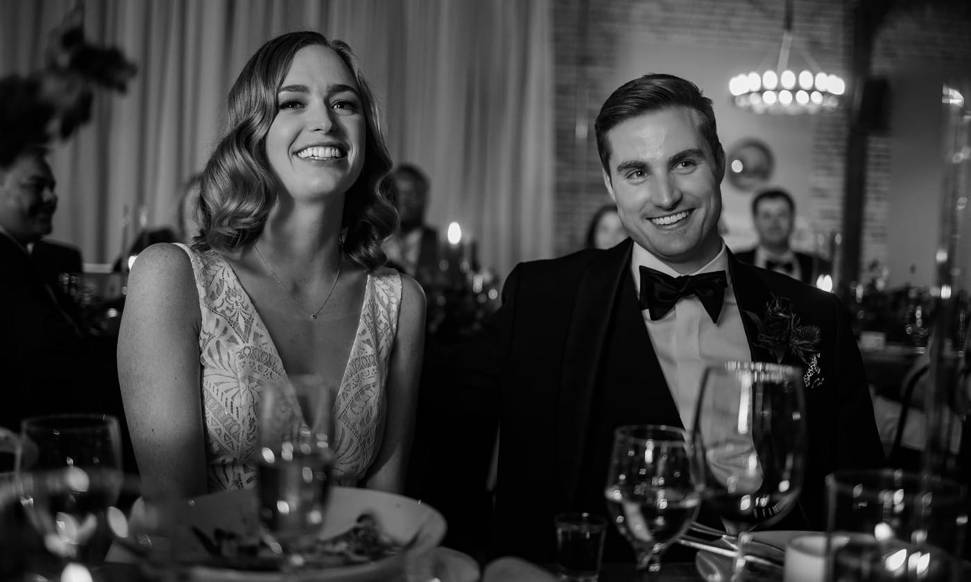 Couple laughing at their reception dinner