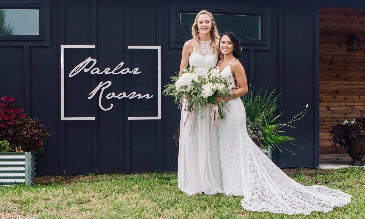 Newlyweds standing in front of Parlor Room Events