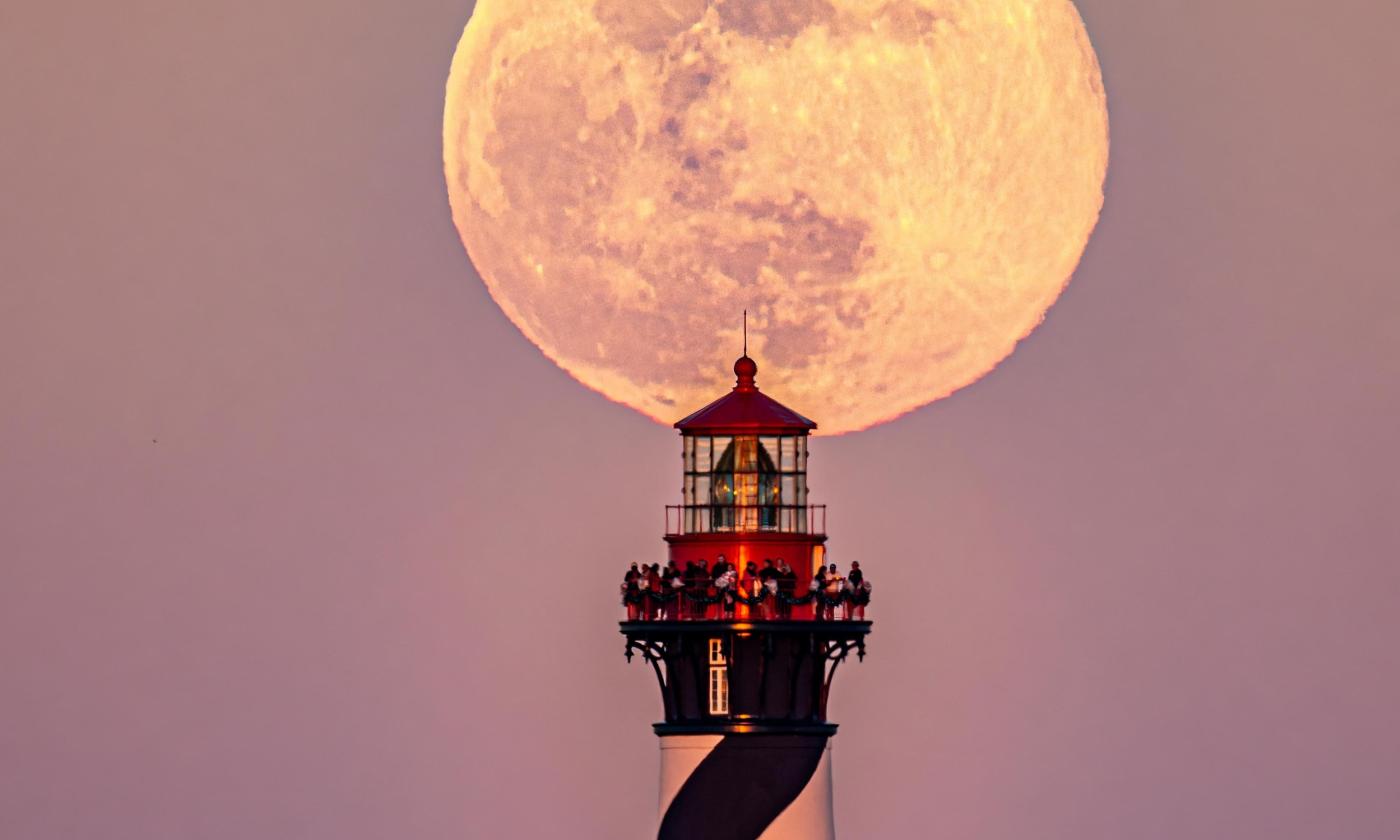 The top of the St. Augustine Lighthouse lit by a full moon