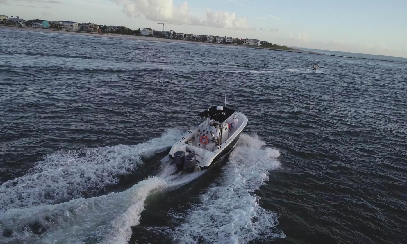 A boat that Wide Open Charters uses in action on the water