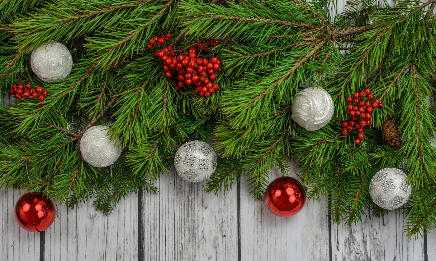 Boughs of greenery, decorated with berries and red and silver ornaments