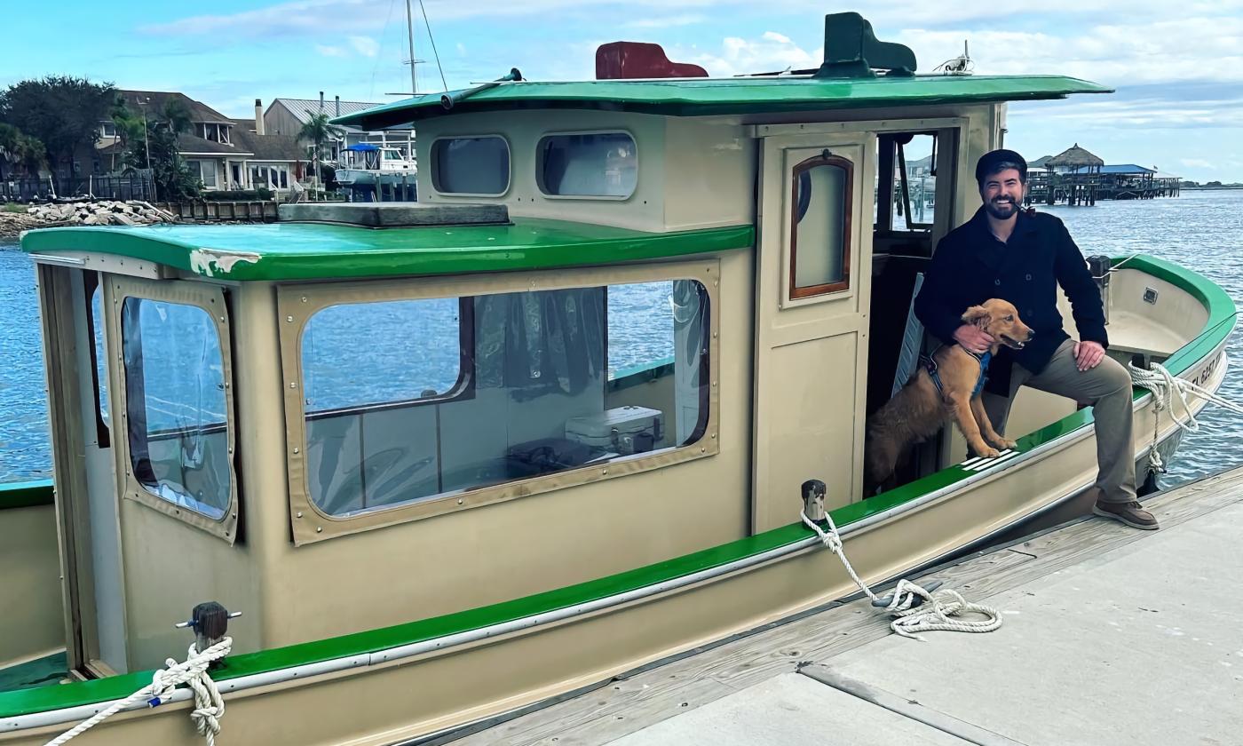 Captain Steve with his dog onboard the tug boat