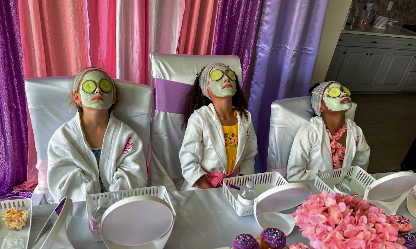 A group of girls relaxing with their face masks on during a spa themed party