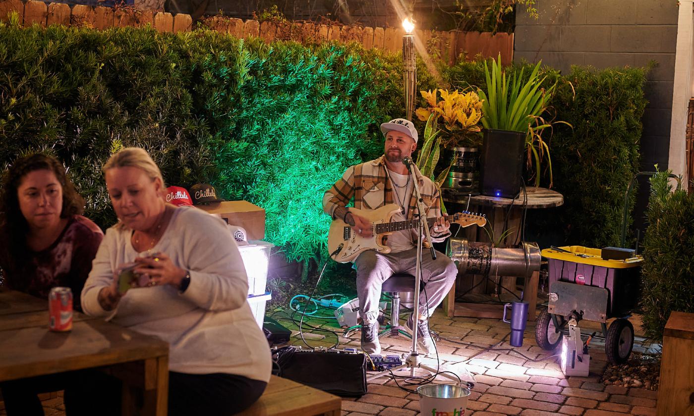 A musician performs outside at the Uptown Block Party