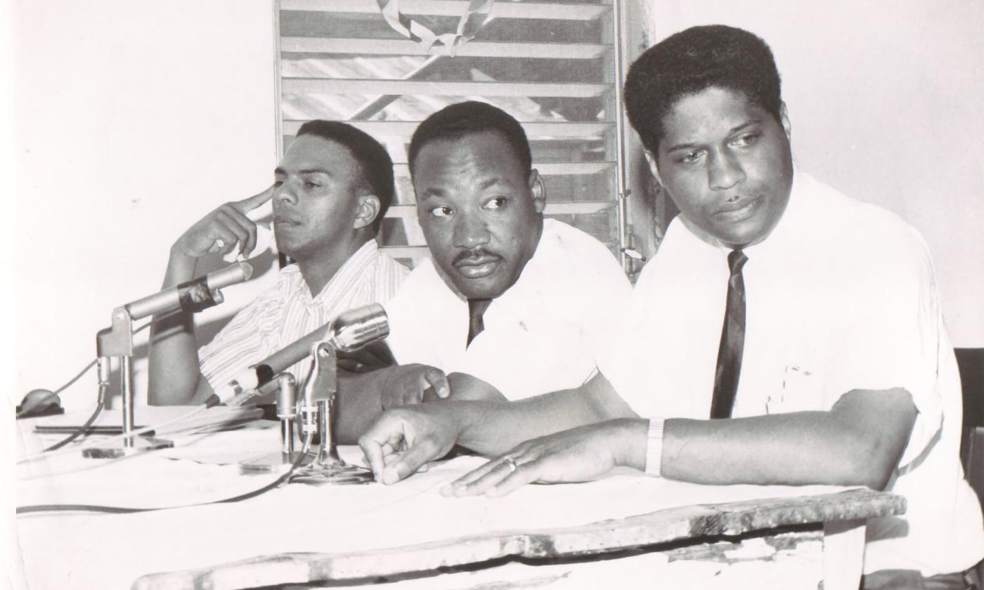 B&W Andrew Young, Dr. MLK Jr., and Dr. R. B. Hayling at a press conference 1964.