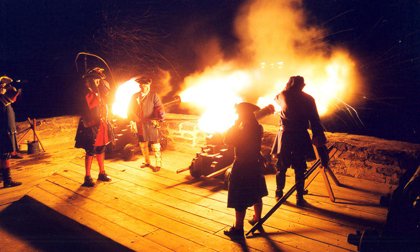 In the dark of night, reenactors at Matanzas Nat'l Monument light cannons that light up in a burst of fire.