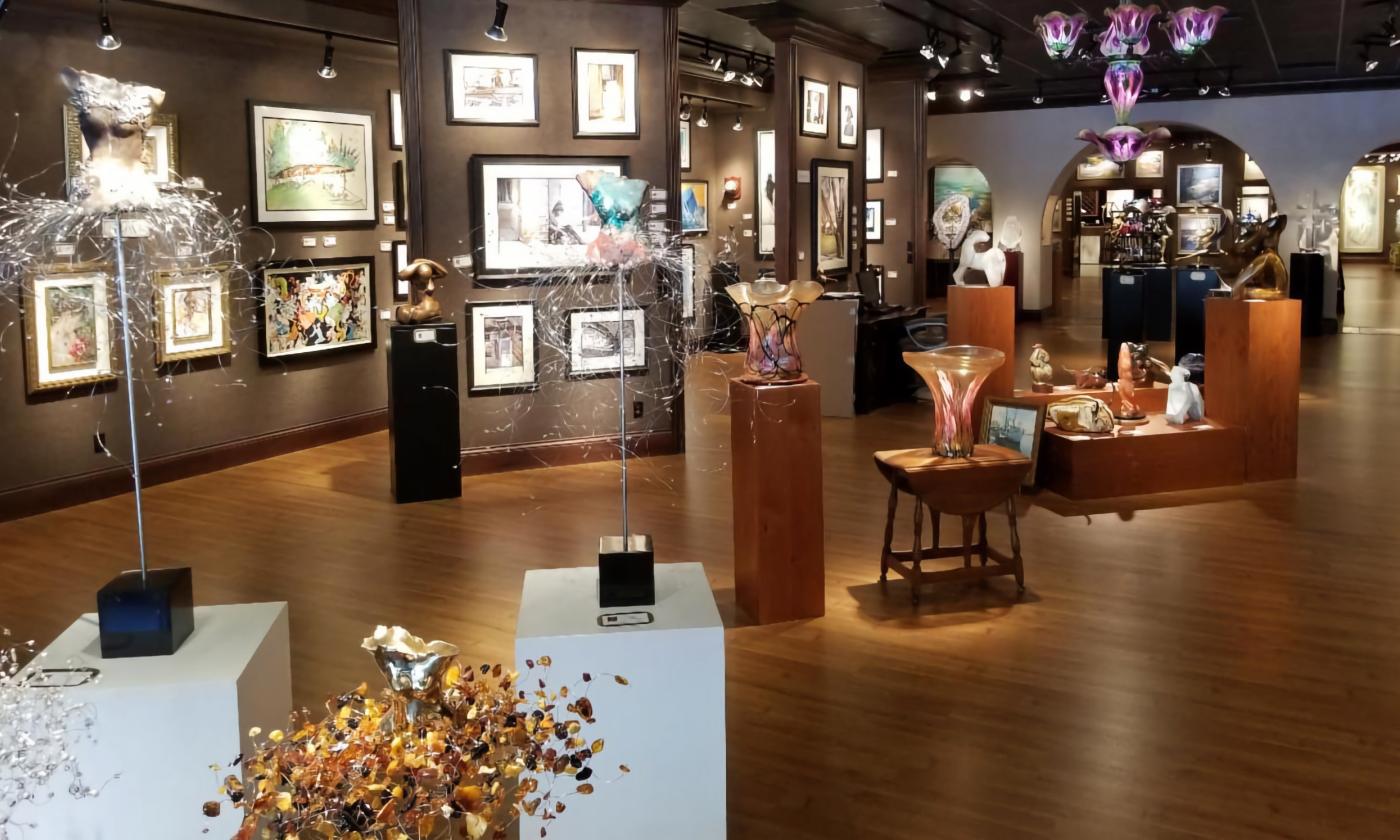 The inside of the art gallery with paintings, prints, and sculptures filling the space