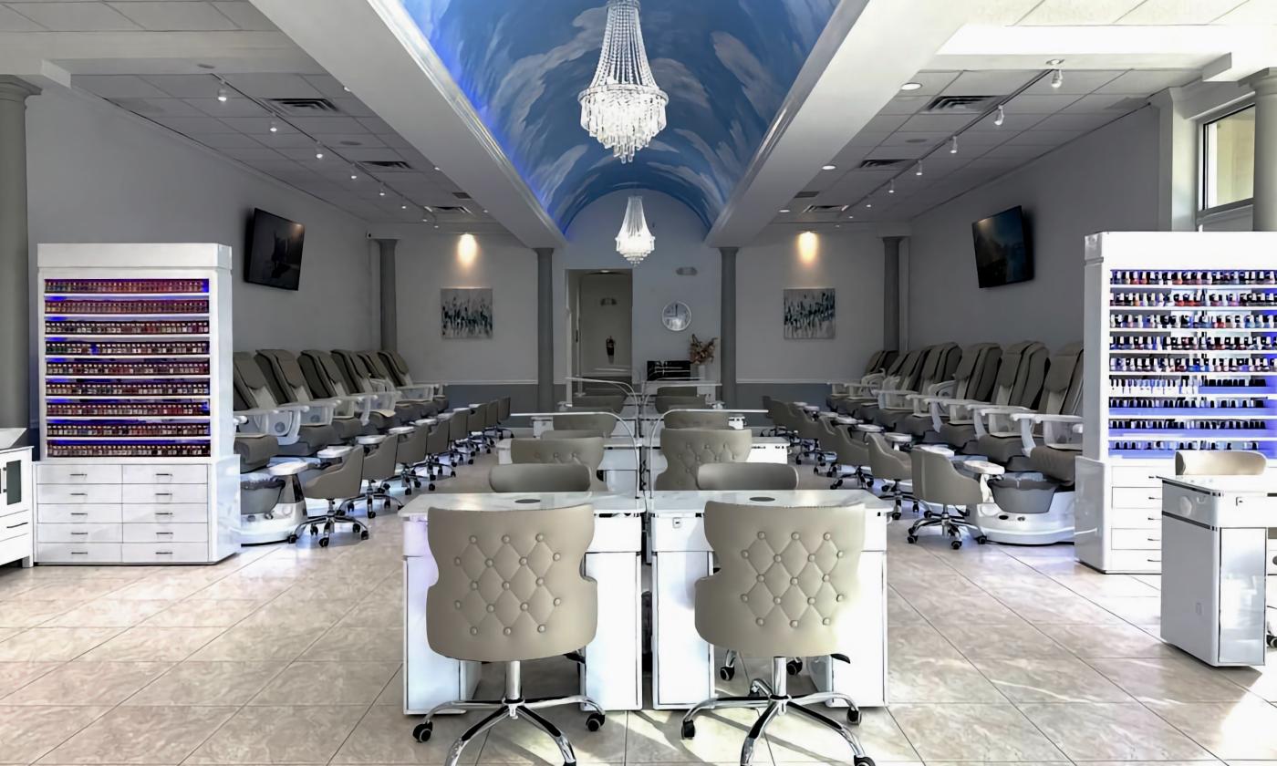 The interior of the M&K Nail Spa with lounge chairs lining the walls