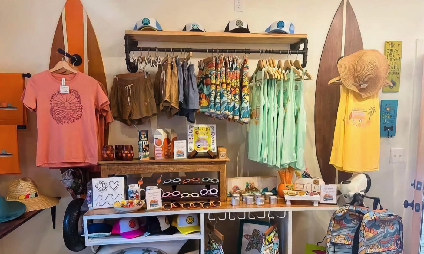 Bright clothing and accessories inside the Stay Sunny shop
