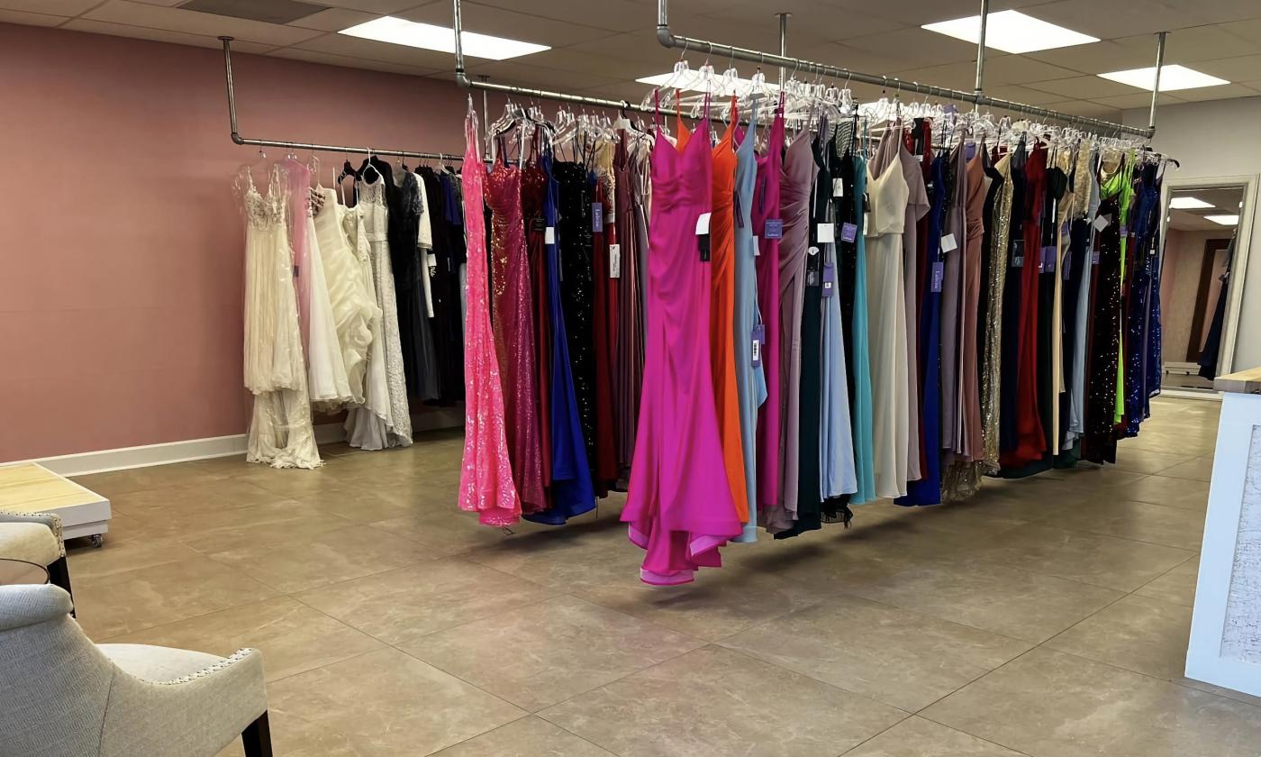 The interior of True Me Boutique with racks of dresses arranged