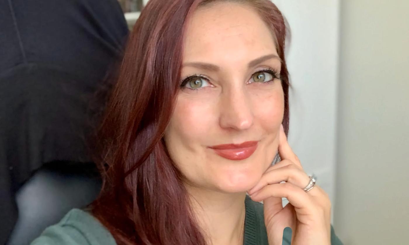 Author Madeline Hunt, from the shoulders up, seated in a desk chair