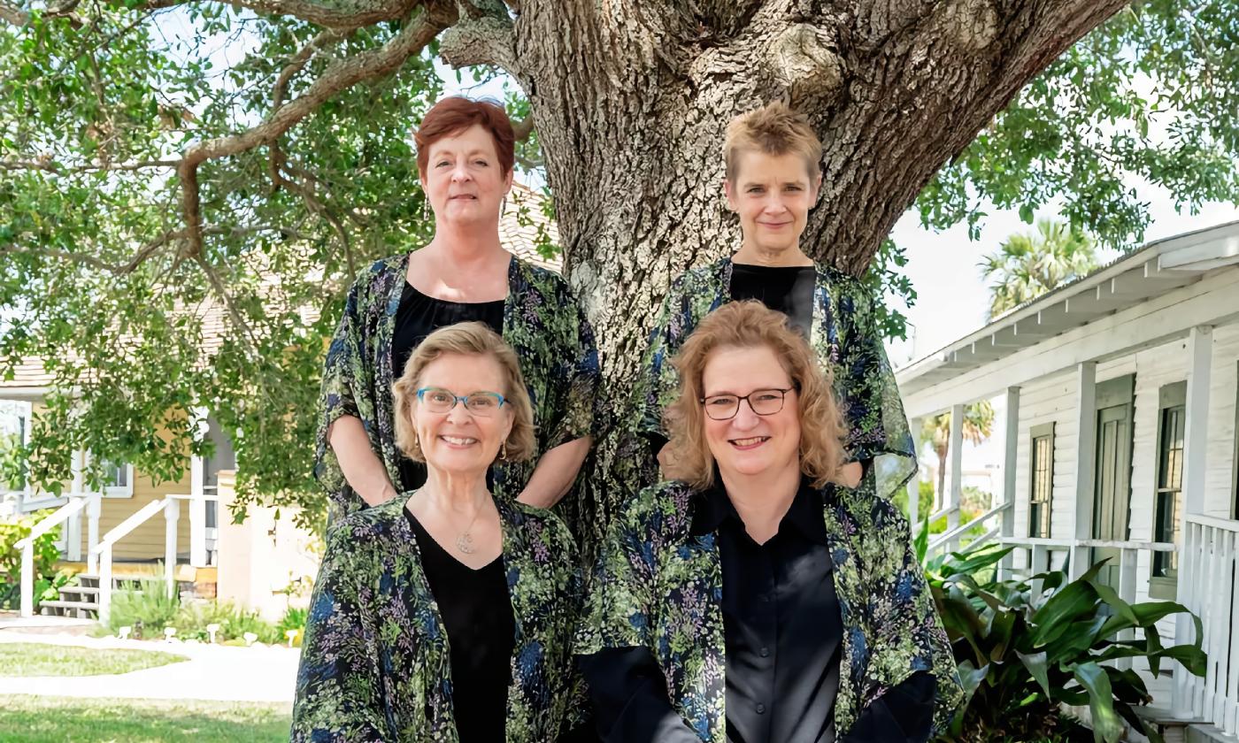 The four members of the Florida Chamber Music Project, stand in front of a live oak