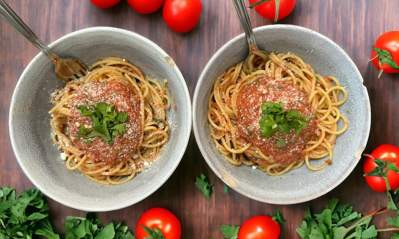Spaghetti bowls with garnishes and seasonings layered on top