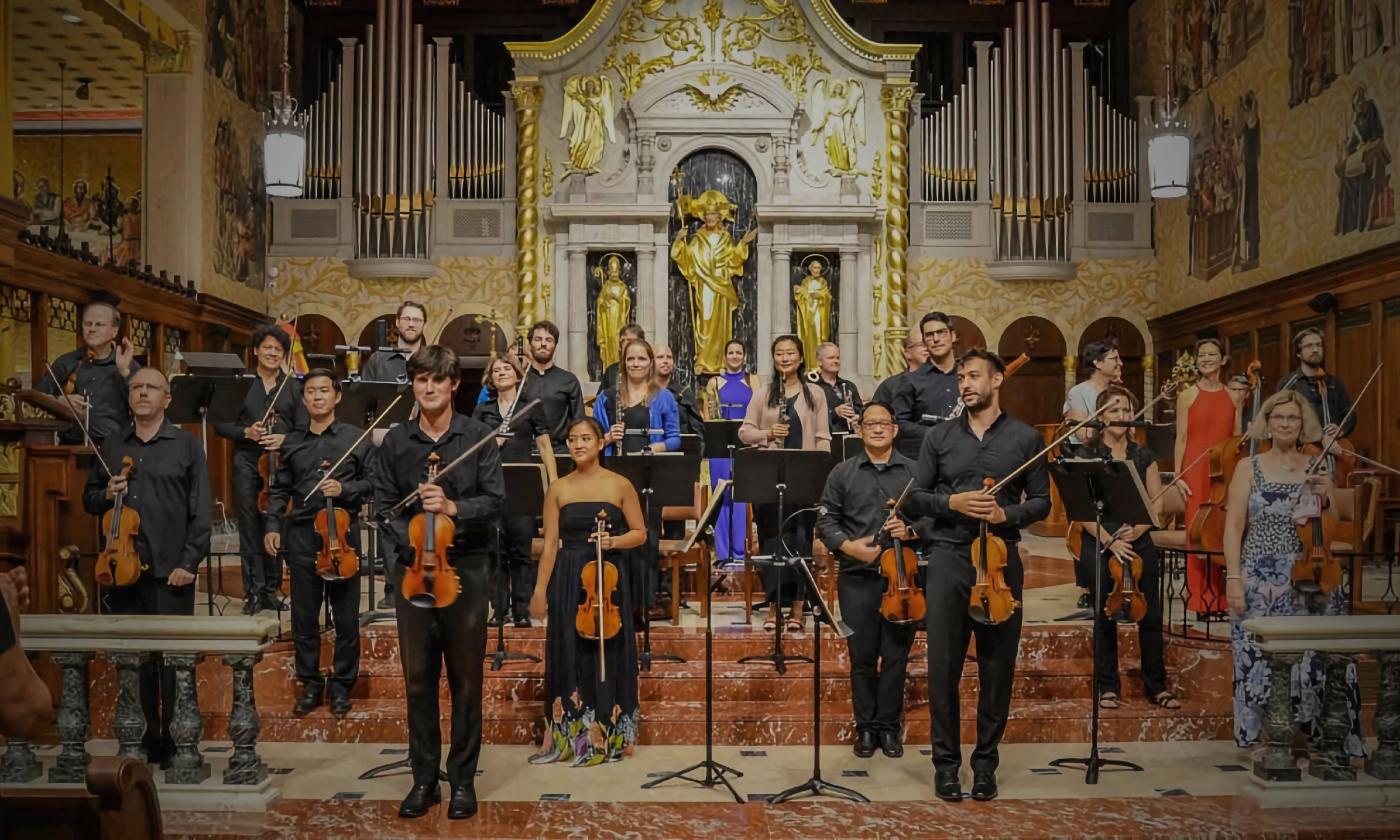 The St. Augustine Music Festival Chamber Orchestra, standing on the Cathedral stage