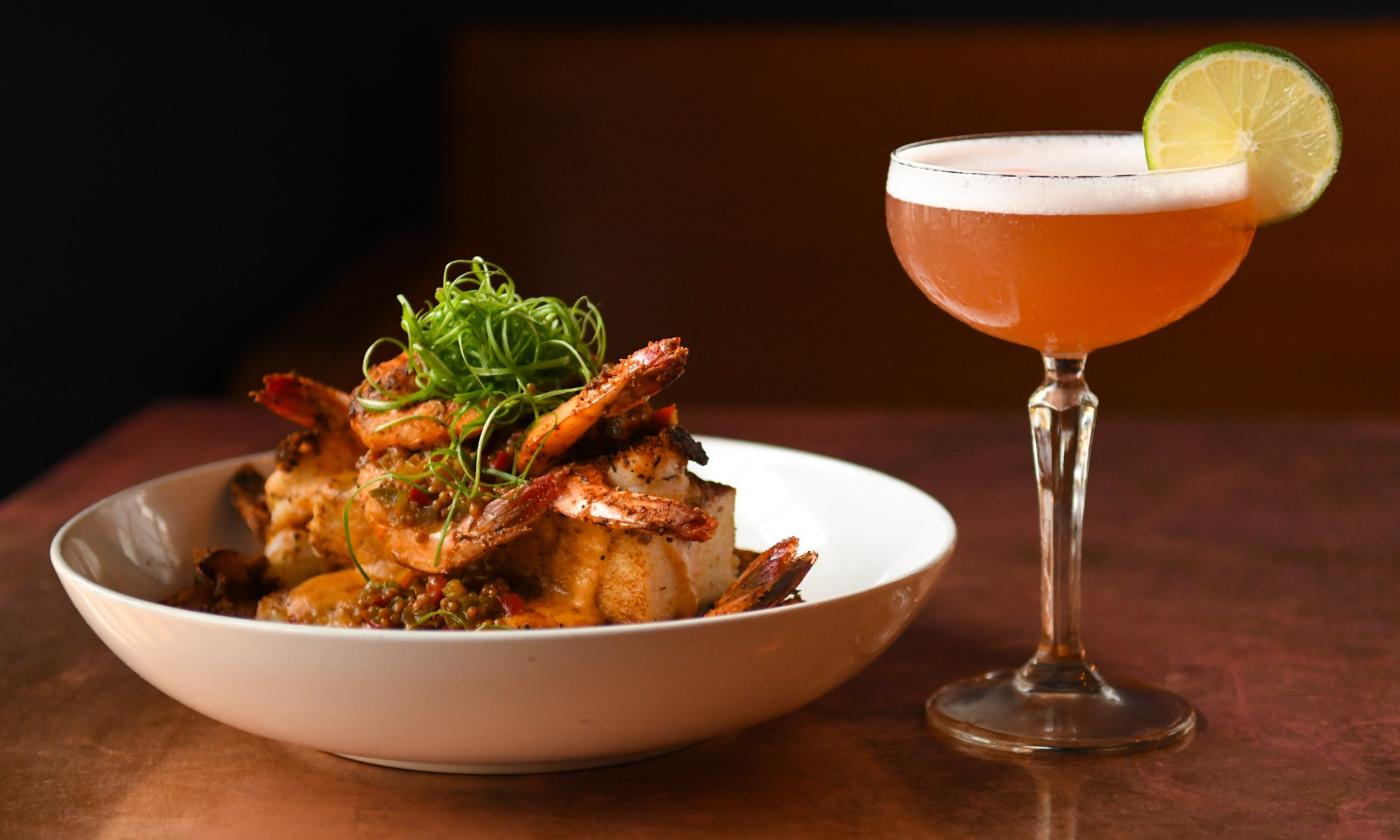 A dish of food and a cocktail