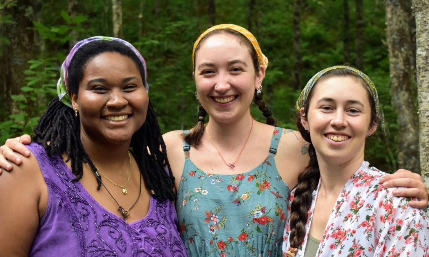 The Little Mercies band of three women standing outside, smiling.