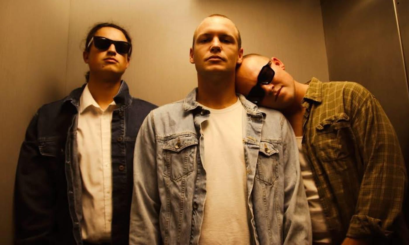 Three band members in an elevator