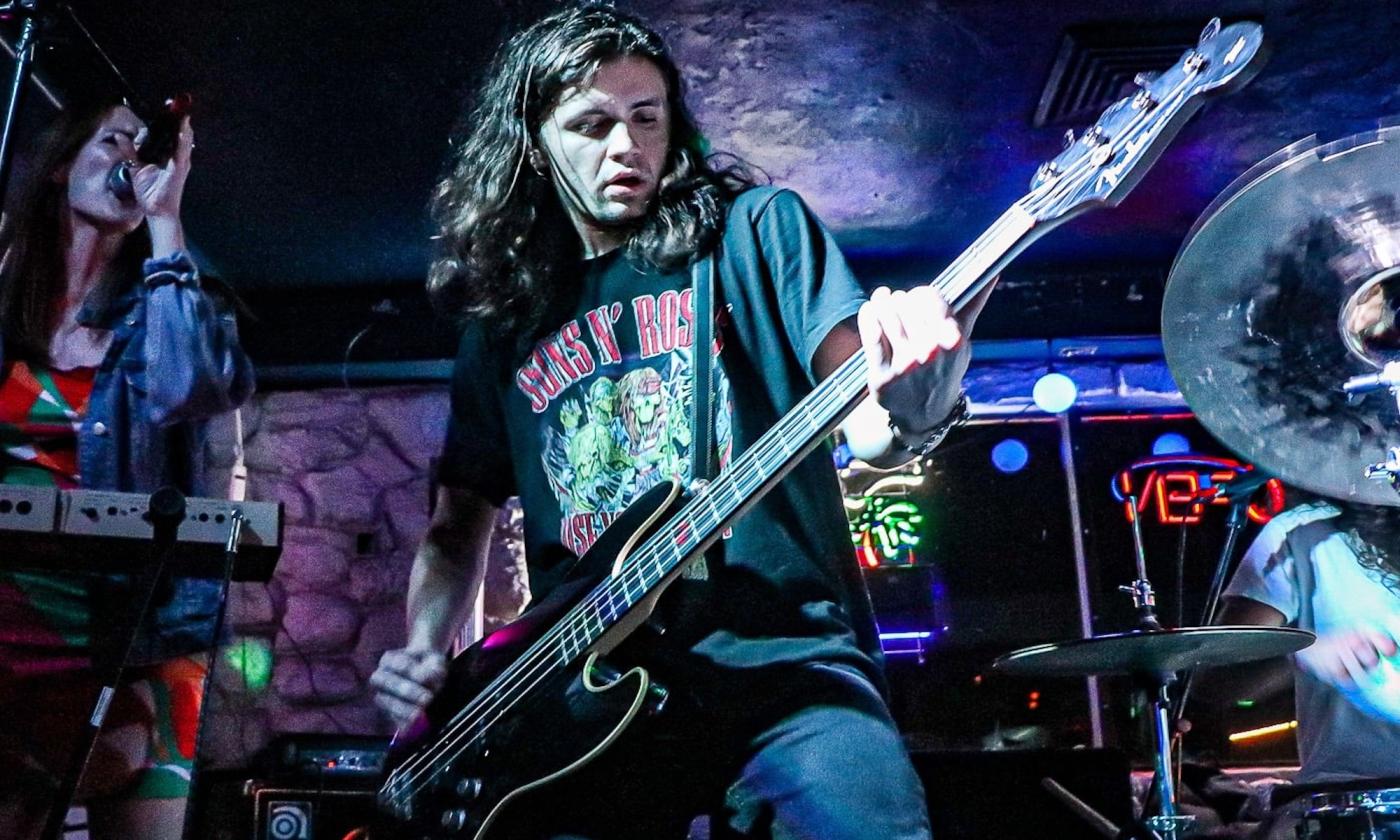 A musician playing a guitar on stage