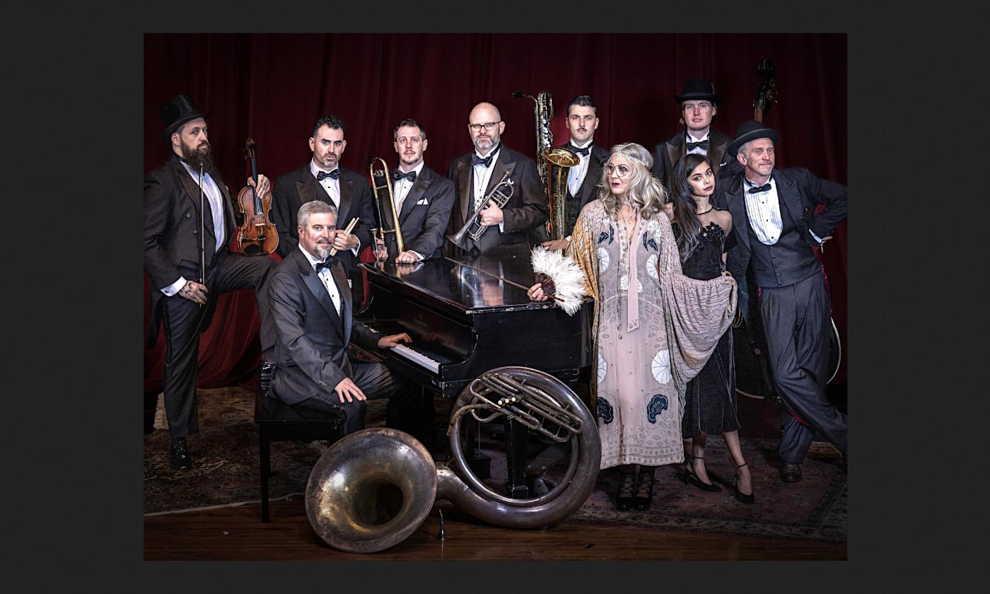 The Squirrel Nut Zipers, around a piano in tuxes and 1920 gowns