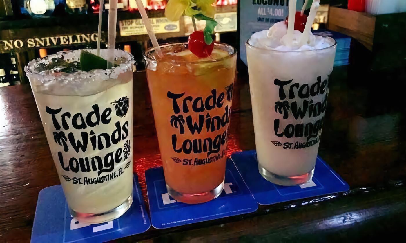 Three tropical drinks from in glasses from Trade Winds Tropical Lounge