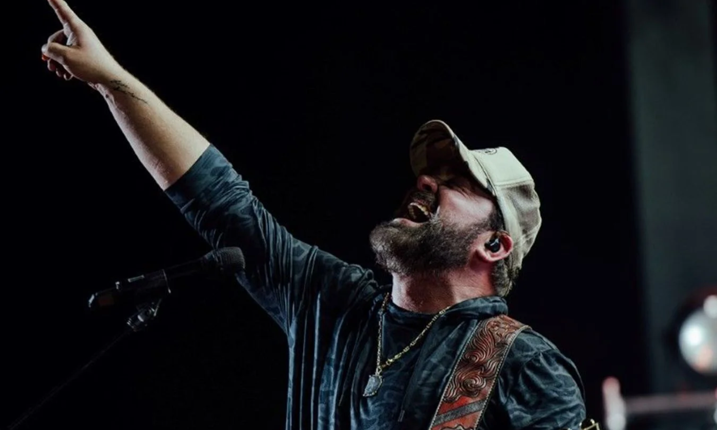 Lee Brice sings and performs on stage.