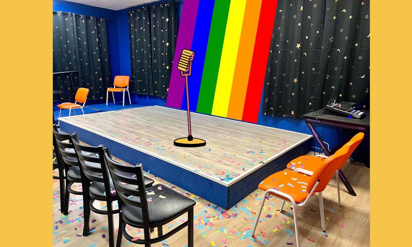 a mic on a stage in front of a rainbow