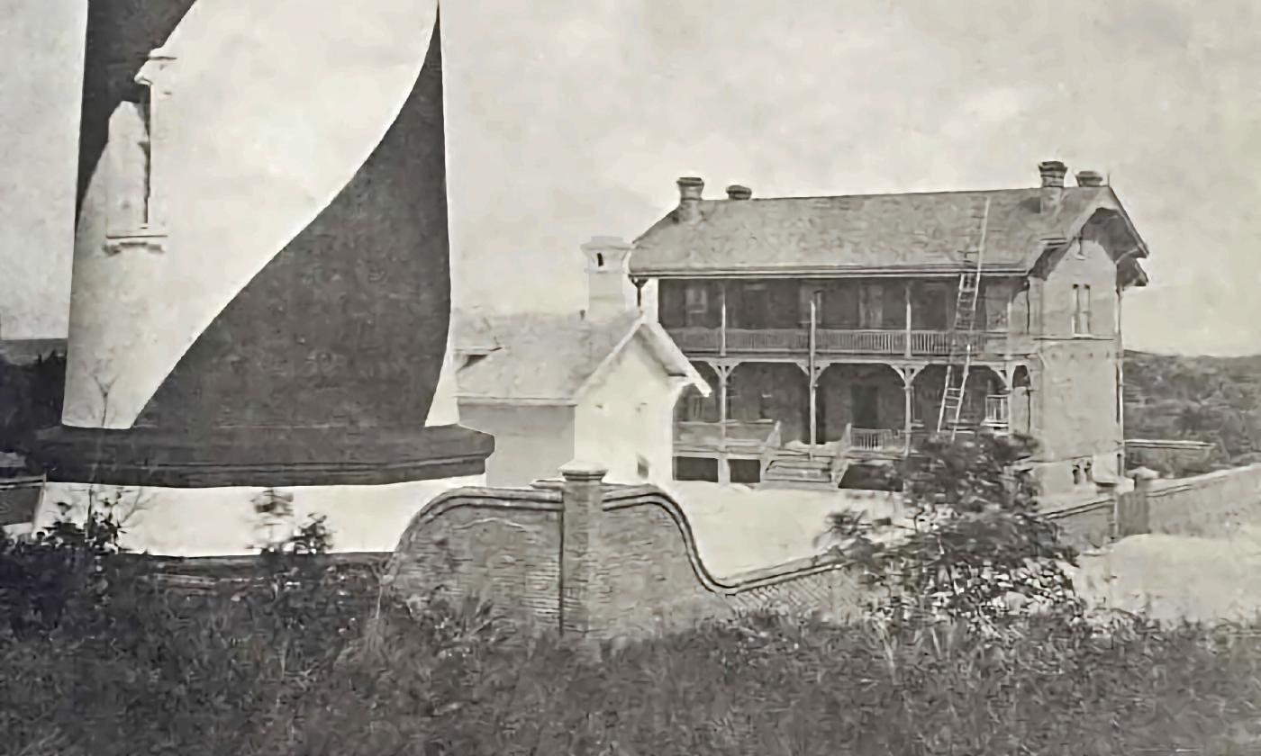 The base of the lighthouse stands next to the ramshackle Keepers' House