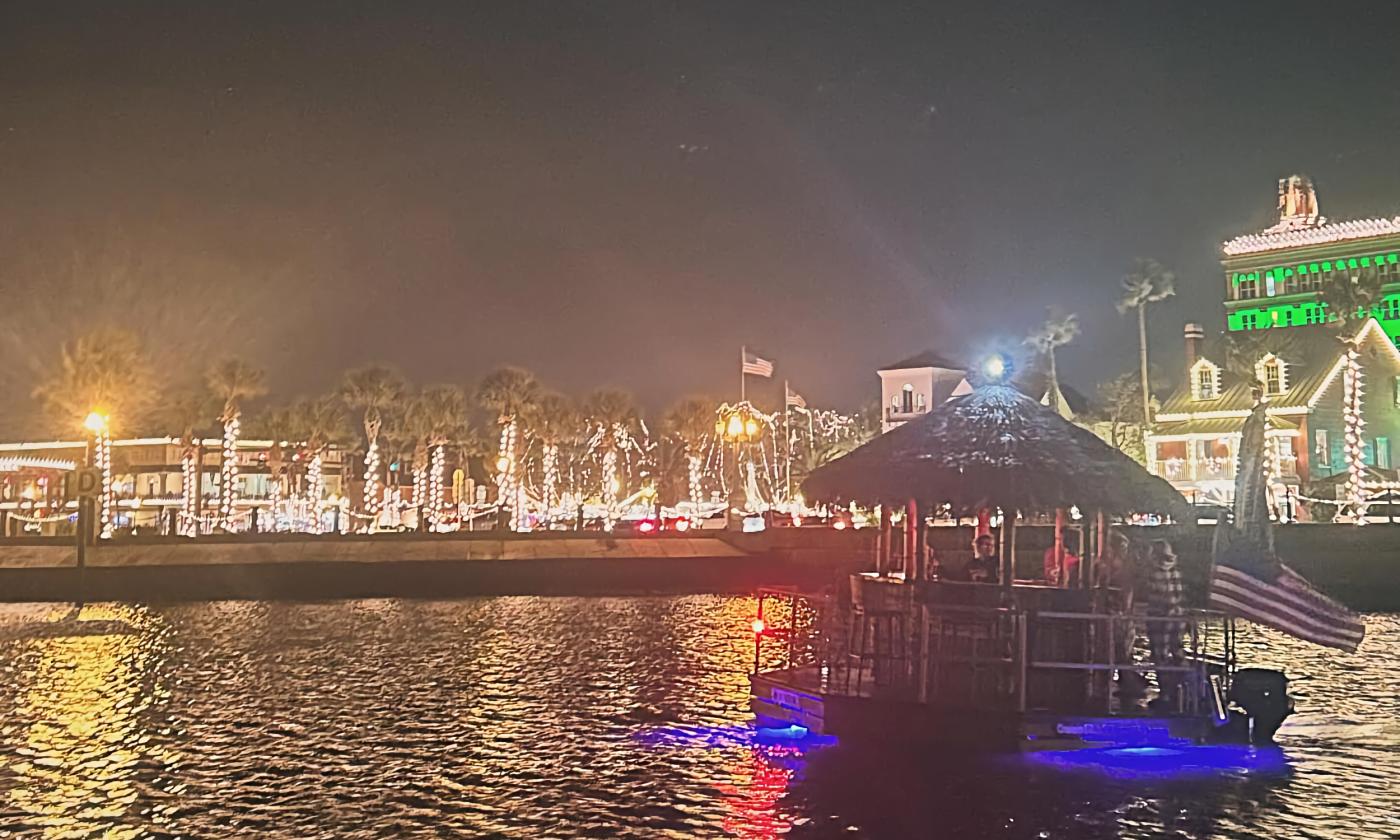A photo of a cruising tiki in front of St. Augustine's bayfront during Nights of Lights