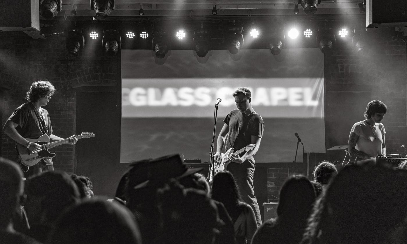 The three members of Glass Chapel on stage in black and white