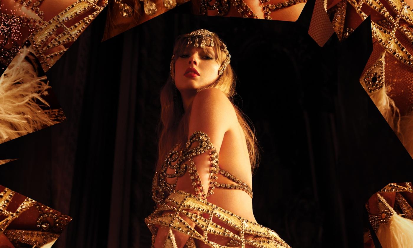 Taylor Swift poses in front of a black backdrop.