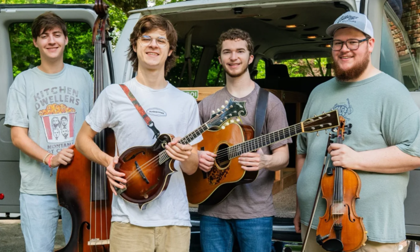 Bandmates from Mountain Grass Unit pose with their musical instruments.