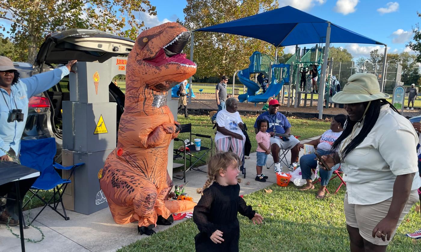 An inflated dinasaur, booths with treats, and lots of open trunks with treats at the Hastings Trunk and Treat