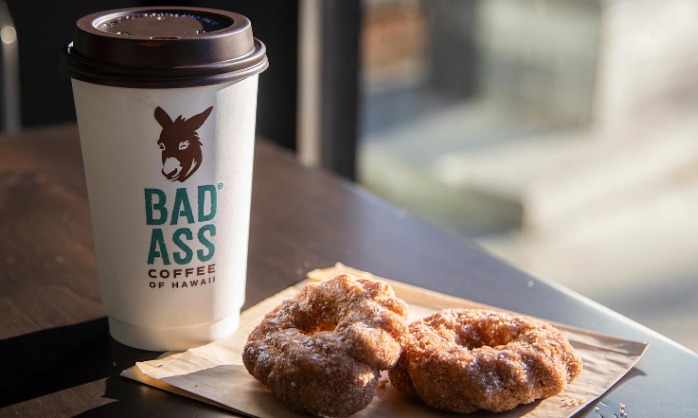 Malasada donuts and a cup of hot coffee