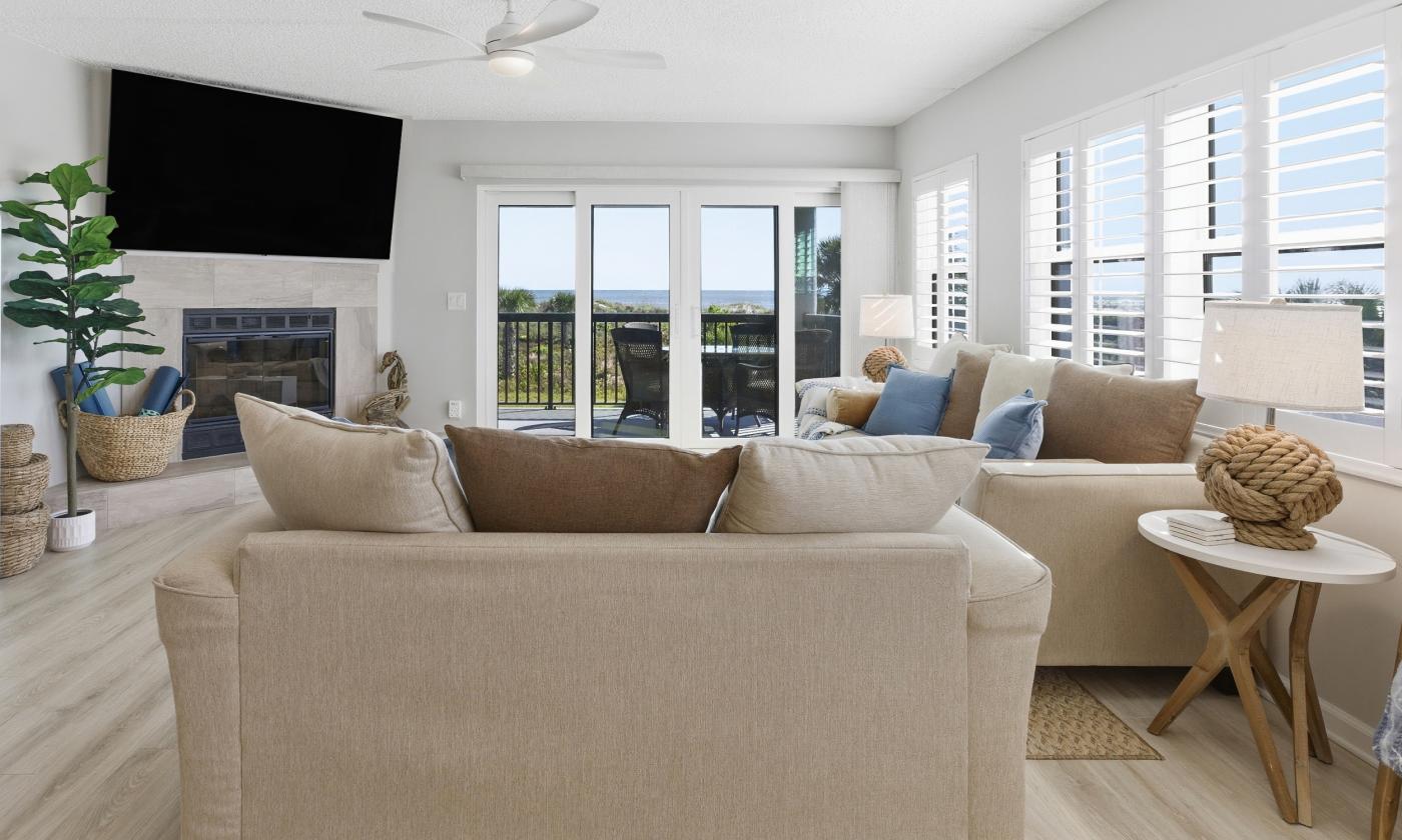 A view of the living room, looking toward the deck with the ocean beyond